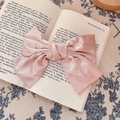 French vintage oversized pink satin bow hair clip with silk texture on book - Hair Bow / Light Pink