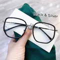 Detail of black and silver oversized glasses frame with striped metal temples on silk - Black Silver