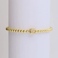 Elastic beaded bracelet in gold finish with a crystal-studded square letter G pendant - Letter G