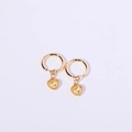 Golden hoop earrings featuring a heart-shaped yellow crystal pendant on white background - November/Citrine Yellow