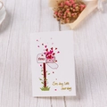 Vertical white Valentine greeting card with red mailbox design on light wood background - Mailbox