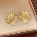 Macro shot of gold-plated geometric stud earrings with hammer texture in a jewelry box - Real Gold Plated Rhombus Style (Silver Pin)