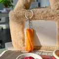 Realistic French fries pendant keychain with golden fried texture on plush brown bag - French Fries Block