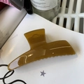 Close-up of a large amber yellow hair claw clip with a glossy acetate finish and metal spring - Autumn Yellow