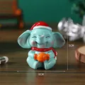 Miniature blue resin elephant ornament with Christmas hat and scarf holding a candy - Elephant - Boxed