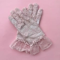 Detail of pink floral lace gloves featuring elegant ruffled cuffs and intricate patterns - Kids One Size / Pink