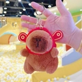 Brown Capybara plush keychain wearing a red Ruyi hat with lucky golden coin patterns - God of Wealth Dark Brown + Gold Clip