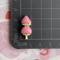 Detailed view of pink resin strawberry charm measured at 3.5cm on a scale grid - Strawberry Strings / Watermelon red