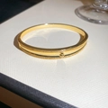 Macro detail of 18k gold plated bangle featuring a sparkling zircon double row design - Center Hulu Gourd Design (3#)