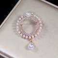 Elegant gold round brooch with white rhinestones, circle pearls, and a large drop pearl pendant - Circular Pearl Pendant