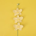 Detailed close-up of three handcrafted yellow crochet orchid flowers with green stems - Three Orchid Branches / Yellow