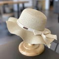 Beige straw sun hat for girls with wavy brim and white bow ribbon on wooden stand - 52CM (2-5 Years Old) / Beige (Hat)