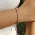 Elegant silver stainless steel olive bead bracelet on a woman wrist with lobster clasp - 2mm / Steel
