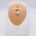 Silver flower belly ring with clear cubic zirconia on a silicone model for display - Hollow Zirconia Flower