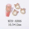 Detail of bow-shaped nail charms with smiley faces and champagne rhinestones on gold base - Champagne (AB86)