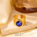 Gold wide band ring featuring embossed texture and a large round blue gemstone inlay - Adjustable Open / Gold Embossed Texture with Round Blue Gemstone (JOM25005)