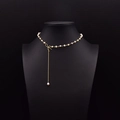 Elegant natural freshwater pearl necklace with gold bow pendant and tassel drop on model - Asymmetric Bowknot Tassel Necklace