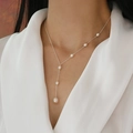 Elegant Y-shaped freshwater pearl necklace with silver chain on model in white shirt - Y-Shaped Style / White