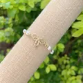 Detailed macro of crystal bow on pearl bracelet with 18K gold plated brass elements - Style 5(5)