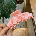 Detail of pink marble acetate hair claw clip held by hand in a cozy lifestyle setting - Large / Pink Cloud