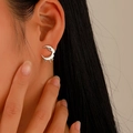 Silver melting crescent moon stud earring worn by a model in a minimalist style - White K (A-785)