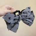 Pince à cheveux grise à motif nœuds noirs pour un coiffage élégant de queue de cheval - Pince à Cheveux Nœud Gris