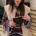 Close-up of brown plush coin purse with beige dots and pink zipper held by a model - Lamb Wool Heart Brown