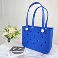 Close-up of blue EVA beach tote with circular ventilation holes and white hardware - Small / Dark Blue
