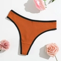 Detailed view of caramel ribbed thong with black trim and decorative floral elements - Dark Orange