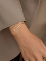 Close-up of double-layer 18K gold plated titanium steel snake and flat blade chain bracelet - Gold