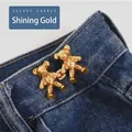 Bear shaped waist tightener pins in shiny gold finish on blue denim jeans - Small / Flowing Gold