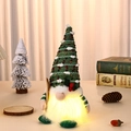 Close-up view of a decorative Christmas gnome night light featuring a green knitted hat - Green Hat Style with Sled