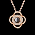 Rose gold four-leaf clover projection necklace with central stone and crystal halo - Clover - Rose Gold