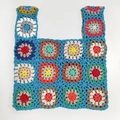 Close-up of colorful handmade crochet tote bag texture with intricate knit patterns - Teal