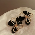 Detail of elegant black and gold double-layer hollow flower studs on silk fabric - Black