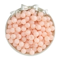 Top view of pink glass beads for jewelry making in a decorative silver bow plate - Floral Opaline Orange Pink Beads