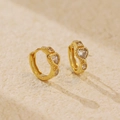 Golden heart-shaped leverback earrings with sparkling cubic zirconia on a stone surface - 925 Silver / Gold