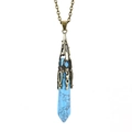 Close-up of hexagonal blue turquoise stone pendant with vintage bronze floral metalwork - Antique Bronze + Blue Turquoise