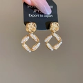 Macro detail of vintage hammered gold square earrings with inlaid pearls and S925 silver pins - Real Gold Plated Gold Style / Gold