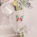 Macro detail of gradient crystal butterfly pendant on gold chain with pavé stones - 1# Multicolor