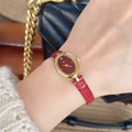 Women's vintage gold oval watch with burgundy leather strap shown on wrist - Gold/Wine Red (Oval)