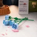Building block set featuring four light blue roses with green stems in a lifestyle setting - 260-09 Single Blue Rose / Bag Packaging