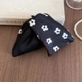 Detail of floral print satin scrunchie with elegant folds on a vintage wooden desk - Hair Claw Clip / Black Floral
