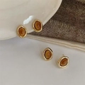 Vintage stainless steel earrings with tiger eye stone set on soft brown knit fabric - Tan