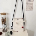 Close-up of white plush crossbody bag featuring a red 3D heart and woven shoulder strap - White Heart Jacquard