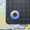 Macro shot of a 2.5cm blue resin lifebuoy accessory on a ruler for size reference - Blue Lifebuoy