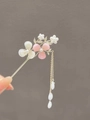 Detail of golden hairpin with pink magnolia flowers, pearls and flowing tassel chain - Cherry Blossom Tassel