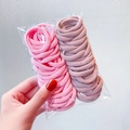 Pink and mauve seamless elastic hair ties set in a clear pouch held by hand - 3# Pink Series