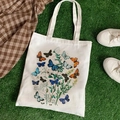 White canvas tote bag with vintage butterfly and floral prints on green grass background - Butterfly & Plant Print (STD344-A)