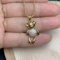 Close-up of golden bear pendant necklace with white zircons and pearl bead chain - Pave Zirconia Style (G)